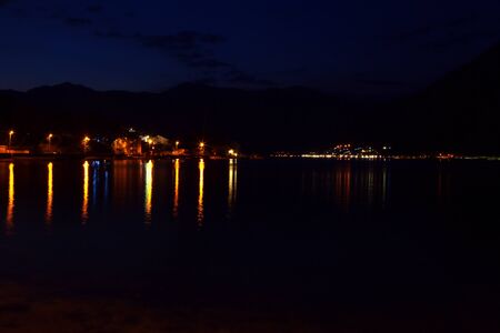 night scene with coastal illuminated town
