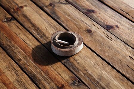 close up image of ashtray on wooden tableの写真素材