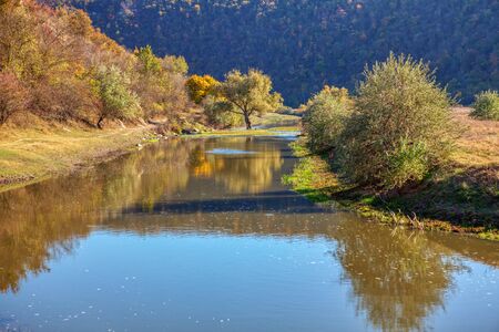 autumnal landscape with flowing riverの写真素材