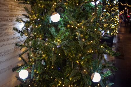 Christmas tree on the street decorated by garlands