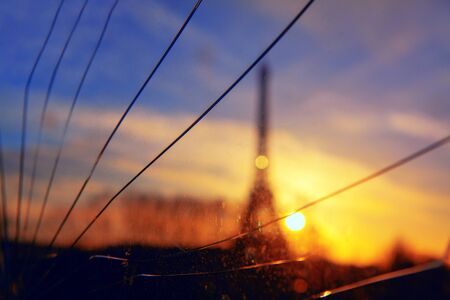 view of the Eiffel Tower through broken glassの写真素材