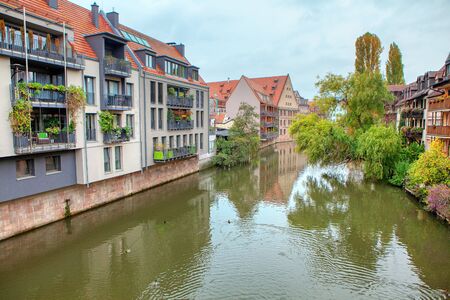 scenery of Pegnitz river with residential houses on the shoreの写真素材