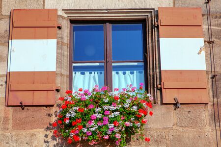 window shutters in retro style with flower bedsの写真素材