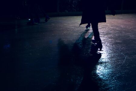 people at the ice rink in the night