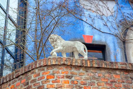 sculpture of the lion on the brick wallの写真素材