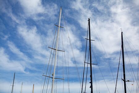 yacht masts and ropes against blue sky