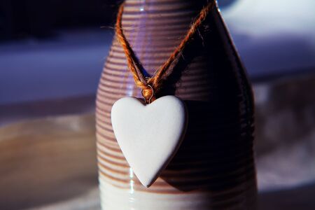 ceramic heart hanging on the bottleの写真素材