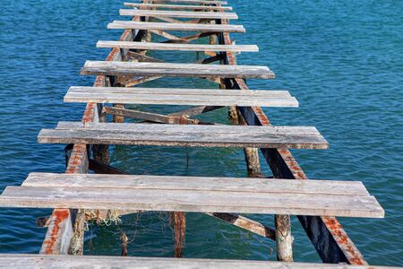 old destroyed river bridge , broken wooden old pierの写真素材