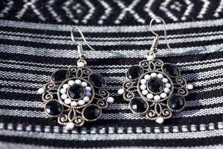 silver earrings decorated with black and white stonesの写真素材
