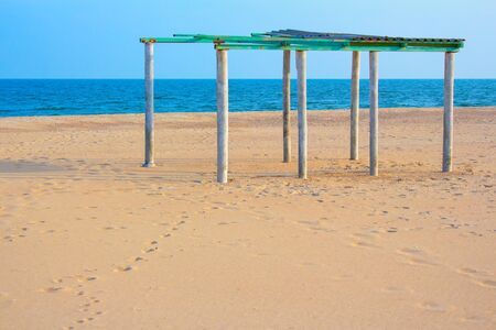 abandoned pavilion at the sandy beachの写真素材