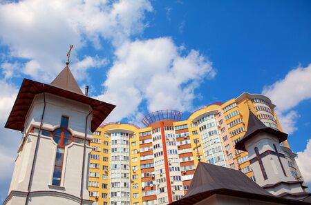 view of church and residential house in the city