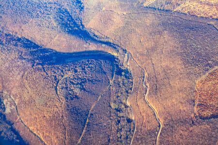 aerial shot of autumn forest at the hills