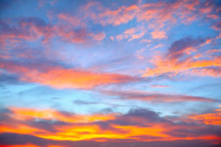 Clouds like heavenly fire . Evening sky with clouds in the twilight
