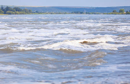 Flowing river water surface with wavesの写真素材