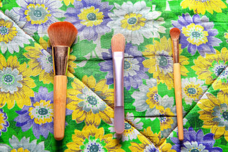 makeup brushes on colourful floral backgroundの写真素材