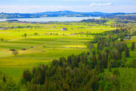 Alpine village situated on Hopfensee lake coast