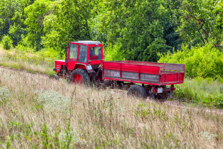 Tractor on a country road . Tractor with trailer in the countrysideの写真素材