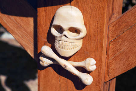 skull and bones carved by wood  . The symbol of earthly deathの写真素材