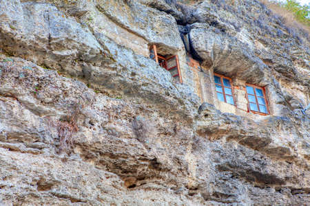 Rocky monastery in Tipova Moldova .  Cave Monastery built into cliffs