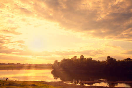 Sunrise over the river . Fishing in the dawn