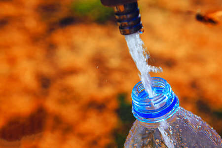 water flows into the plastic bottle