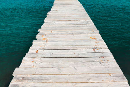 Wooden path over the water . Footbridge to the seaの写真素材