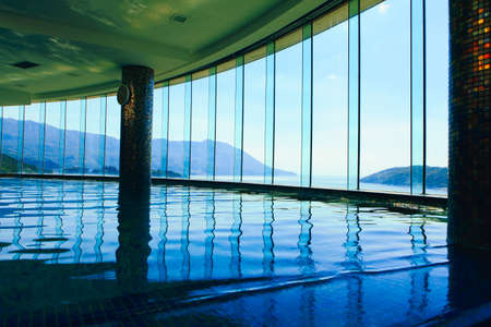 Luxury swimming pool at the hotel top . Majestic panoramic view of mountains and seaのeditorial素材