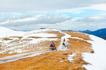 Winter adventure with snowmobile on the mountainsの写真素材