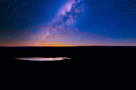 Milky way over the dark hill . fantastic sky in the nightの写真素材