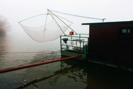 Fishing platform with wagon . Fishing in the foggy morning