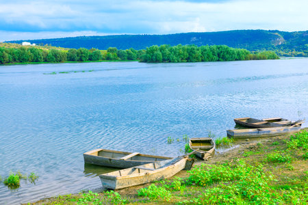 Fishing rustic wooden Boats at the riverside. Beautiful morning sceneryの写真素材