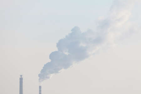 Air Pollution in the City . Steam of industrial smoke comes from the pipes