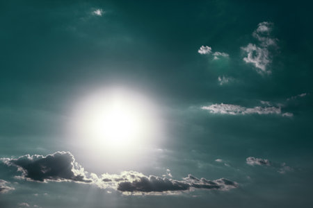 Cold bright sun with clouds on the skyの写真素材