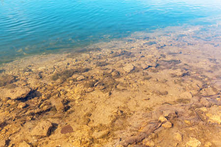 River bottom with stones . Transparent coastal water