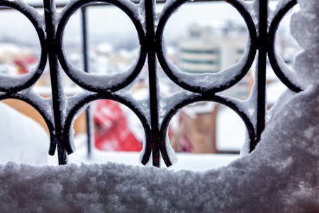 Snow on the window grates , winter background