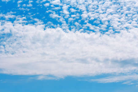 Altocumulus on the blue sky . Summer clouds