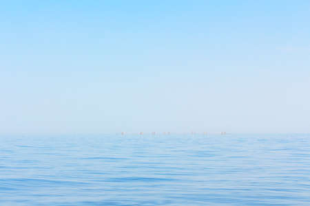 Blue sea horizon . Marine scenery with fishing pillarsの写真素材