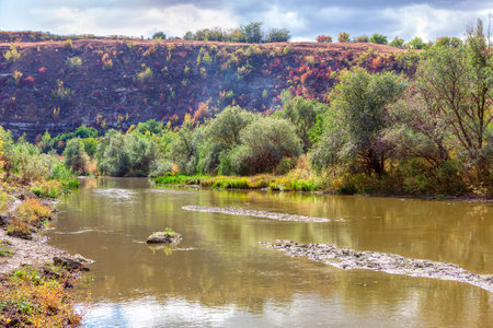 Shallow river water surrounded by hillsの写真素材