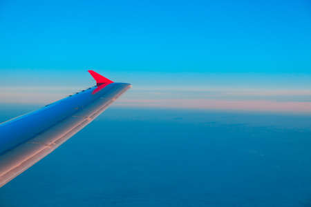 Airplane wing outside, view from interior of aircraftの写真素材