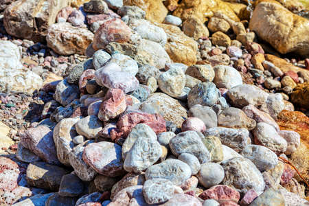 coastal pebbles , beach rough surface , hot stones on the shoreの写真素材
