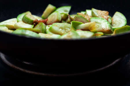 Zucchini are fried in a pan . Traditional vegetable rustic cookingの写真素材