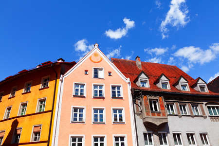 Colorful tenement houses with attics . Facade with Sundial . European residential districtのeditorial素材