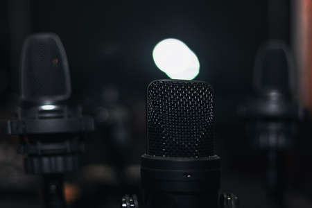 Black microphones in the dark studioの写真素材