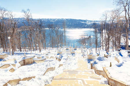 Scara Cascadelor in Chisinau Moldova . Valea Morilor lake and park in the wintertime . City park staircase covered by snowの写真素材