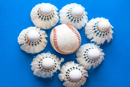 Baseball ball and shuttlecocks at blue backgroundの写真素材