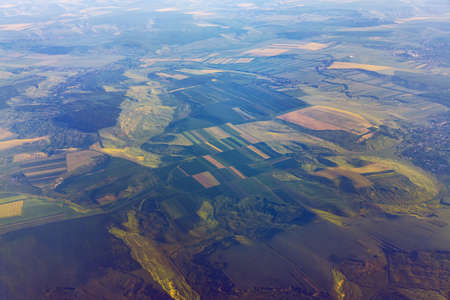 Aerial landscape with green meadows . Countryside view from the plane windowの写真素材
