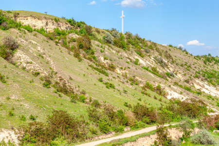 Rocky hill with religious cross on the topの写真素材