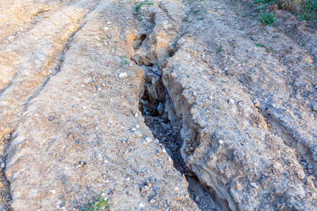 Country road washed away by the downpour . Holes in the ground after the torrential rainの写真素材