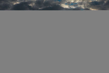 Dramatic sky with twilight . Dusk with black cloudsの写真素材