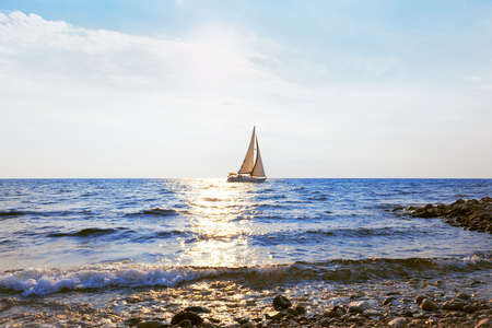 Sailing yacht in sunlight . Yacht view from the coastの写真素材